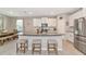 Kitchen with a large island and stainless steel refrigerator at 2164 Midnight Pearl Dr, Sarasota, FL 34240