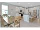 Well-equipped kitchen with granite countertops, stainless steel appliances, and adjacent dining area at 2164 Midnight Pearl Dr, Sarasota, FL 34240