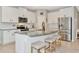Kitchen featuring white cabinets, a granite island, and stainless-steel appliances at 2164 Midnight Pearl Dr, Sarasota, FL 34240
