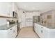 Bright kitchen features white cabinetry, stainless steel appliances, and granite countertops at 2164 Midnight Pearl Dr, Sarasota, FL 34240