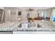 Open-concept kitchen with stainless steel sink and granite countertops, perfect for entertaining at 2164 Midnight Pearl Dr, Sarasota, FL 34240