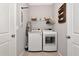 Modern laundry room with updated washer and dryer, and organized storage solutions at 2164 Midnight Pearl Dr, Sarasota, FL 34240