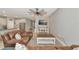 Spacious living room featuring a leather couch and a coffee table, adjacent to a modern kitchen at 2164 Midnight Pearl Dr, Sarasota, FL 34240
