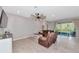 Comfortable living room features neutral paint, large windows, and plush leather seating at 2164 Midnight Pearl Dr, Sarasota, FL 34240