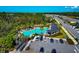 Resort style community pool with lounge chairs and palm trees in a beautiful community at 2164 Midnight Pearl Dr, Sarasota, FL 34240