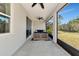 Relaxing screened-in patio with comfortable seating and peaceful backyard views at 2164 Midnight Pearl Dr, Sarasota, FL 34240