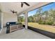 Inviting screened porch features a comfortable seating area and a view of lush greenery at 2164 Midnight Pearl Dr, Sarasota, FL 34240