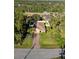 Single-Gathering house with a paved driveway and solar panels at 2200 Pratt Avenue, North Port, FL 34286