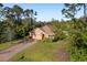 Single-Gathering home with a large backyard and surrounding trees at 2200 Pratt Avenue, North Port, FL 34286
