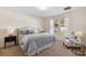 Spacious bedroom with a large bed, nightstand, and comfortable armchair at 2200 Pratt Avenue, North Port, FL 34286