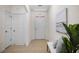 Bright entryway with tile floors, bench, and artwork at 2200 Pratt Avenue, North Port, FL 34286