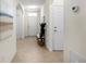 Hallway with light walls, tile floors, and doors at 2200 Pratt Avenue, North Port, FL 34286
