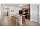 Modern kitchen with island, wooden cabinets, and barstools at 2200 Pratt Avenue, North Port, FL 34286