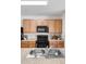 Clean and bright kitchen with granite countertops and black appliances at 2200 Pratt Avenue, North Port, FL 34286