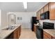 Modern kitchen with black appliances and light wood cabinets at 2200 Pratt Avenue, North Port, FL 34286