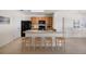 Modern kitchen with island, stainless steel appliances, and light wood cabinets at 2200 Pratt Avenue, North Port, FL 34286