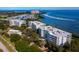 Aerial view of waterfront apartment buildings and manicured landscaping with ocean view at 2550 Harbourside Dr # 322, Longboat Key, FL 34228