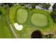 Aerial shot of the putting green, showing the lush greens, sand trap, and small pond that make for a challenging game at 2550 Harbourside Dr # 322, Longboat Key, FL 34228