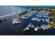 Aerial view of a marina filled with yachts and boats on a clear day, showcasing the luxury and elegance of waterfront living at 2550 Harbourside Dr # 322, Longboat Key, FL 34228