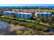 Scenic aerial view of waterfront condos and marina with well-manicured grounds and serene views at 2550 Harbourside Dr # 322, Longboat Key, FL 34228
