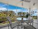 This condo boasts a balcony featuring a sleek table and seating arrangement, perfect for enjoying the amazing view at 2550 Harbourside Dr # 322, Longboat Key, FL 34228