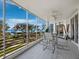 Balcony featuring outdoor seating and stunning views of manicured green space, mature trees and a sparkling blue ocean at 2550 Harbourside Dr # 322, Longboat Key, FL 34228