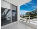 Bright, well-lit balcony featuring white tile, a minimalist white railing, and serene views of the outdoors at 2550 Harbourside Dr # 322, Longboat Key, FL 34228