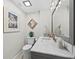 Stylish bathroom with a marble countertop, framed mirror, and light gray cabinets at 2550 Harbourside Dr # 322, Longboat Key, FL 34228