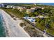 Beautiful beach with sand and covered picnic areas near multi-story waterfront condo buildings at 2550 Harbourside Dr # 322, Longboat Key, FL 34228