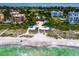 Aerial shot of a sandy beach with covered picnic areas and the Gulf in the background at 2550 Harbourside Dr # 322, Longboat Key, FL 34228
