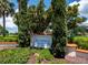 Longboat Key Club Moorings Marina Village signage surrounded by lush greenery, showing the beauty of the neighborhood at 2550 Harbourside Dr # 322, Longboat Key, FL 34228