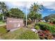 Community sign 'Marina Bay' amongst palm trees, flowers, and lush landscaping at 2550 Harbourside Dr # 322, Longboat Key, FL 34228