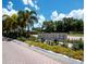Bay Isles North Longboat Key Club entrance sign surrounded by beautiful landscaping and mature palm trees on a bright day at 2550 Harbourside Dr # 322, Longboat Key, FL 34228