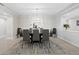 Elegant dining room featuring a modern chandelier, stylish decor, and ample natural light at 2550 Harbourside Dr # 322, Longboat Key, FL 34228