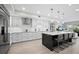 Gourmet kitchen with stainless steel appliances, custom cabinets, an island with seating, and modern lighting at 2550 Harbourside Dr # 322, Longboat Key, FL 34228