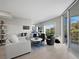 Bright living room with neutral decor, comfortable seating, and a sliding glass door to the outside balcony at 2550 Harbourside Dr # 322, Longboat Key, FL 34228