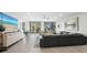Contemporary living room with a large sectional sofa, flat screen tv, and access to a balcony at 2550 Harbourside Dr # 322, Longboat Key, FL 34228