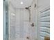 Bright shower features stylish tile work and modern fixtures with beautiful bronze finish at 2550 Harbourside Dr # 322, Longboat Key, FL 34228