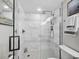 Modern shower features white marbled tile, glass shower enclosure, and built in features at 2550 Harbourside Dr # 322, Longboat Key, FL 34228