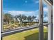 Serene lawn and ocean view through a large window fills the room with natural light at 2550 Harbourside Dr # 322, Longboat Key, FL 34228