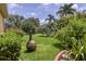 Landscaped backyard with fire pit and lush foliage at 2773 Harvest Dr, Sarasota, FL 34240