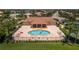Community pool with clubhouse and surrounding homes at 2773 Harvest Dr, Sarasota, FL 34240
