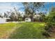 Large backyard with lush lawn and mature trees at 2826 Marlette St, Sarasota, FL 34231
