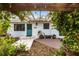 Charming home exterior with teal door and brick patio at 2826 Marlette St, Sarasota, FL 34231