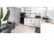 Small galley kitchen with black refrigerator and granite counters at 2826 Marlette St, Sarasota, FL 34231