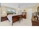 Main bedroom with wood furniture, a large bed, and access to the backyard at 308 Matisse E Cir, Nokomis, FL 34275