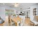 Open concept dining area with a wood table and kitchen views at 308 Matisse E Cir, Nokomis, FL 34275