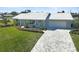 Updated single-story home with a large driveway and landscaped lawn at 308 Matisse E Cir, Nokomis, FL 34275