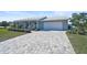 Newly renovated home featuring a paver driveway and curb appeal at 308 Matisse E Cir, Nokomis, FL 34275
