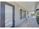 Inviting front porch with rocking chairs and updated door at 308 Matisse E Cir, Nokomis, FL 34275